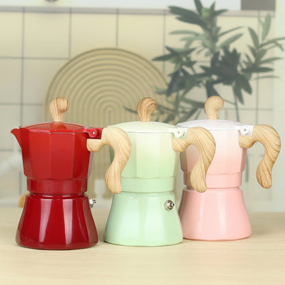 cafetiere expresso italienne verte rose et rouge degrade sur table bois
