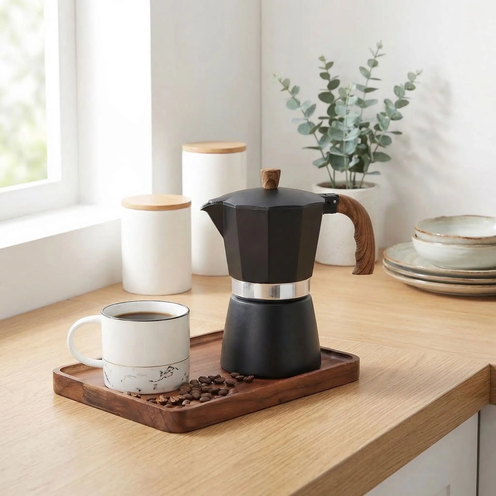 cafetière italienne sur plateau en comptoir cuisine tasse cafe grain a cote fleur pot et assiette en decor