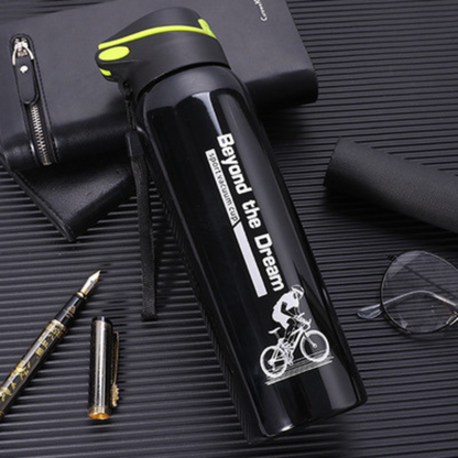 gourde isotherme velo noire sur table calpin lunette stylo a cote
