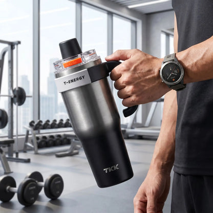 mug etanche isotherme gris noire tenu par un homme a la salle de sport