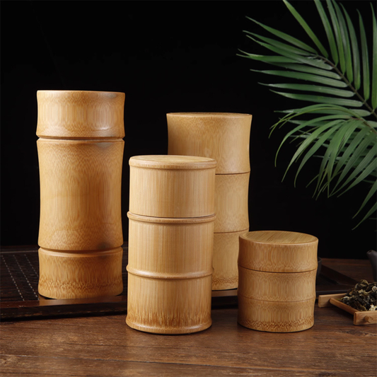 quatre boite a the en bois dimensions differente sur table thé et plante à coté
