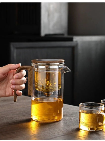 femme tenant theiere en verre servant the dans tasse